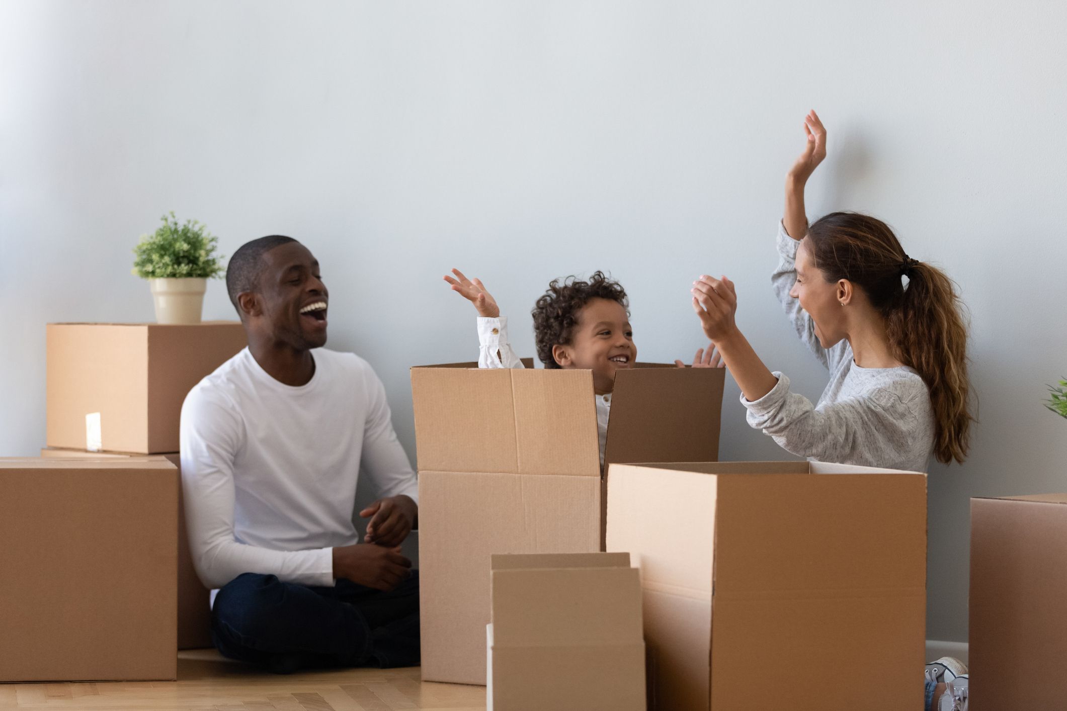 Family playing in empty moving boxes