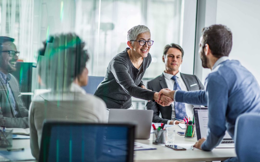 Business woman shaking hand of new employee