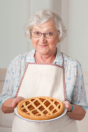 Elderly woman holding a pie