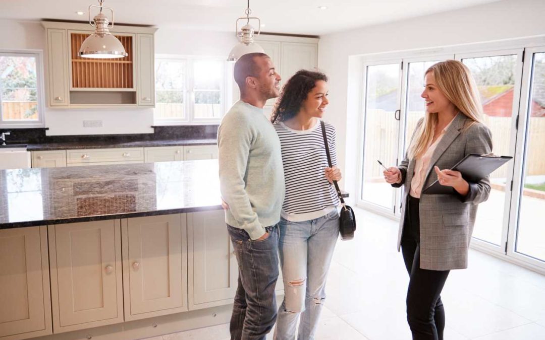Realtor showing a home to a young couple
