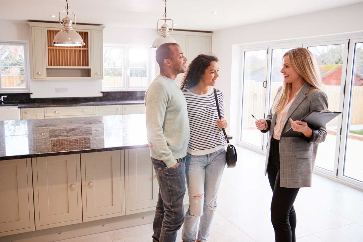 Realtor showing a home to a young couple
