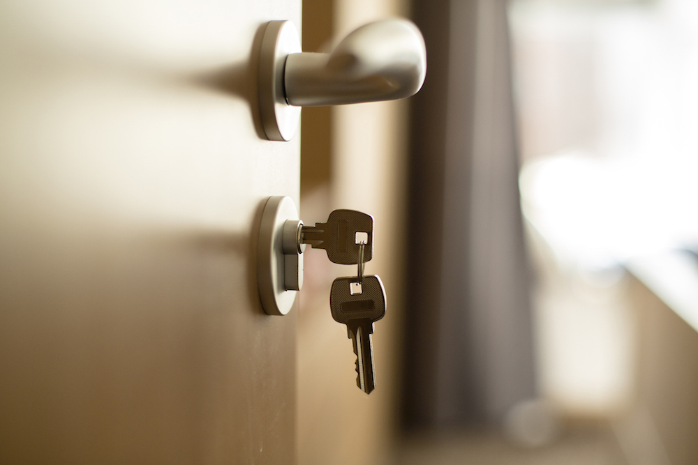 Keys to a home hanging is a door lock