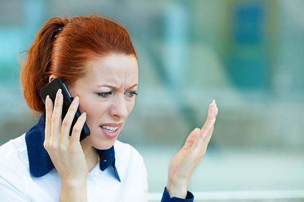 Distraught woman talking on cell phone