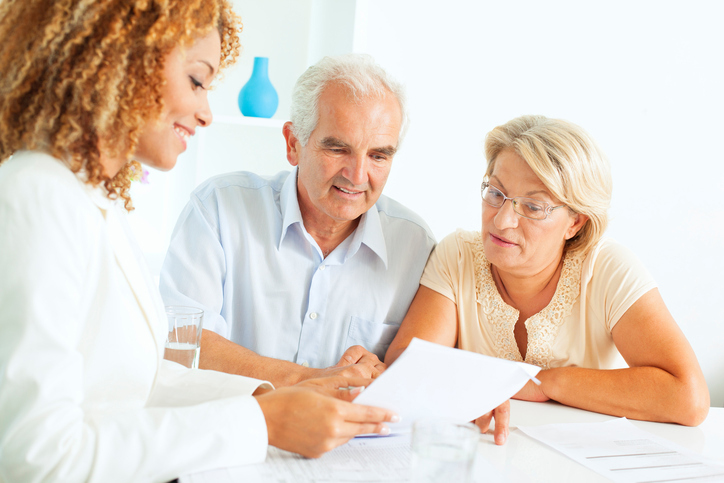 Mature couple working with female lawyer doing estate planning
