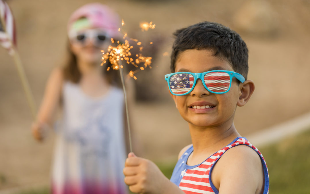Young boy and girly with sparklers celebrating July 4th Independence Day