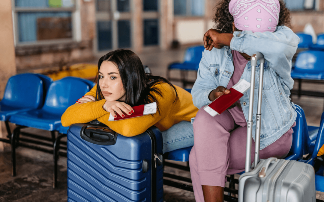 Two women in an airport upset because their flight has been delayed or cancelled.
