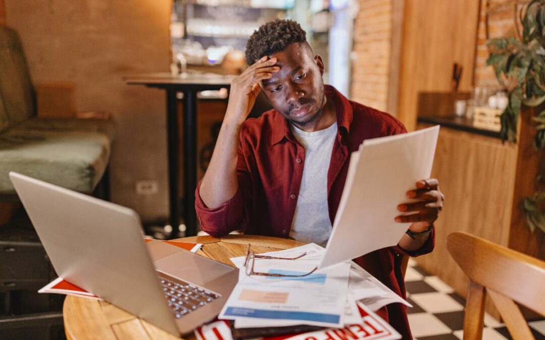A small business owner stressed while filing his business taxes