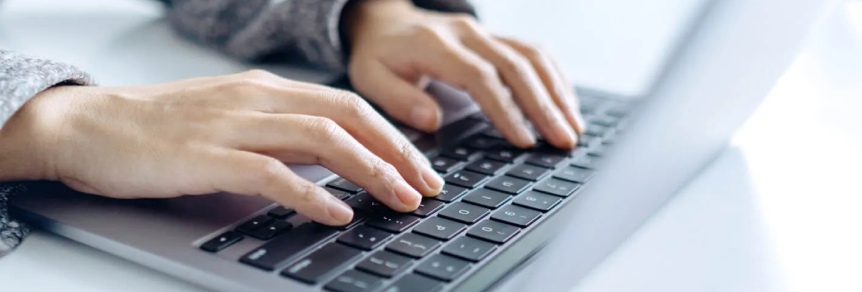 Person typing a LegalShield Trustpilot review on a laptop.